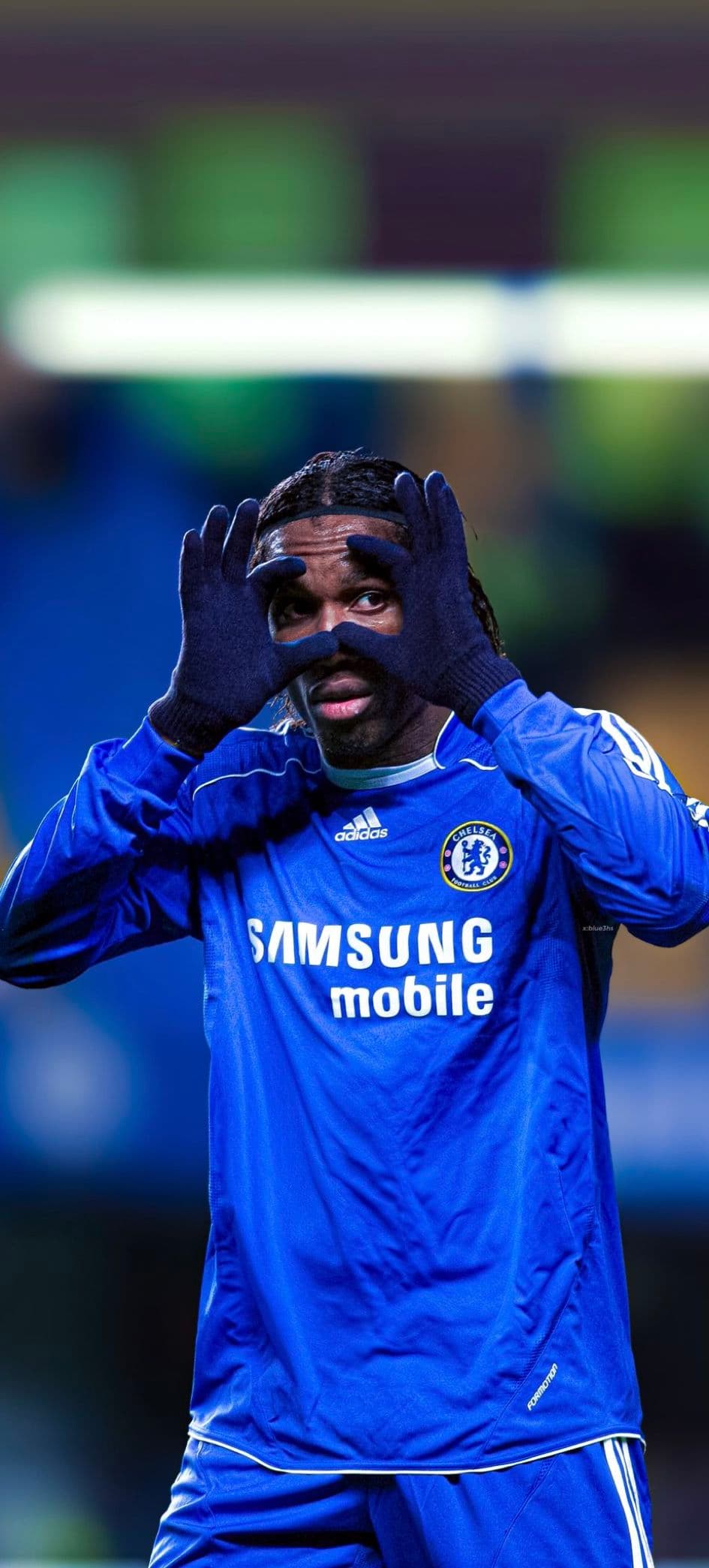 Braids-era Didier Drogba in the 2007/08 Samsung mobile Chelsea kit making a goggles gesture